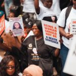 Protesters holding signs: Being a woman should not be a death sentence, End Femicide in Kenya