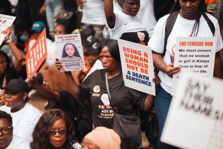 Protesters holding signs: Being a woman should not be a death sentence, End Femicide in Kenya